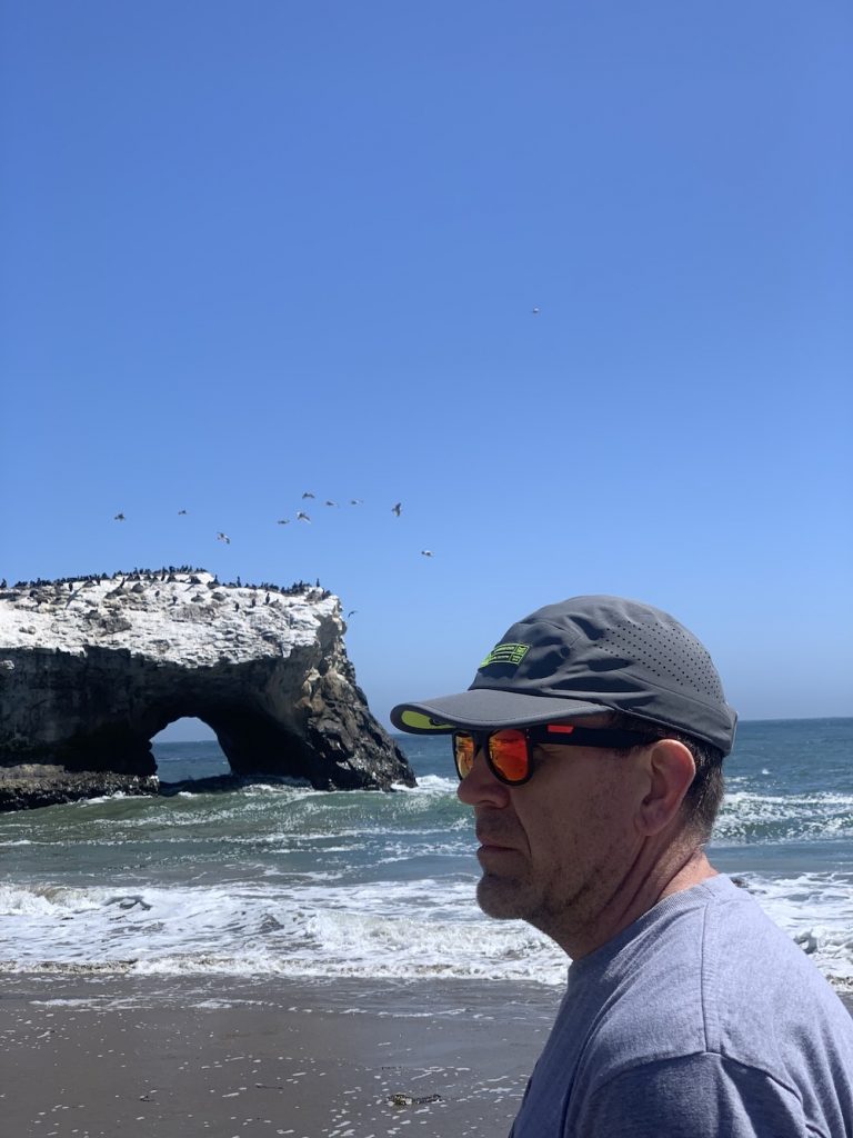 melin pace hydro hat side view on a beach