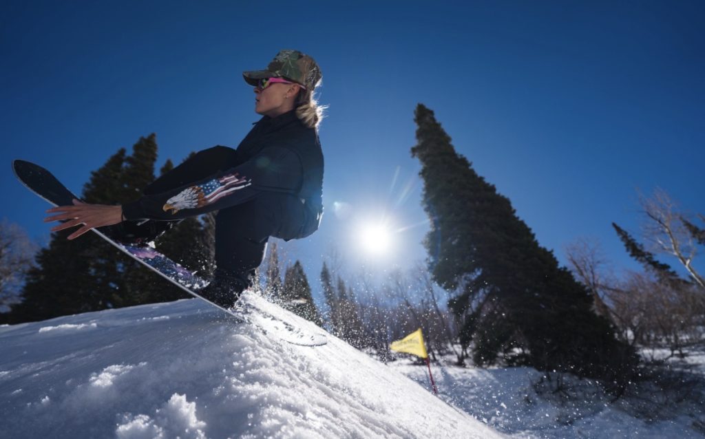 Caroline jumping on the Never Summer Women's Proto Type #3